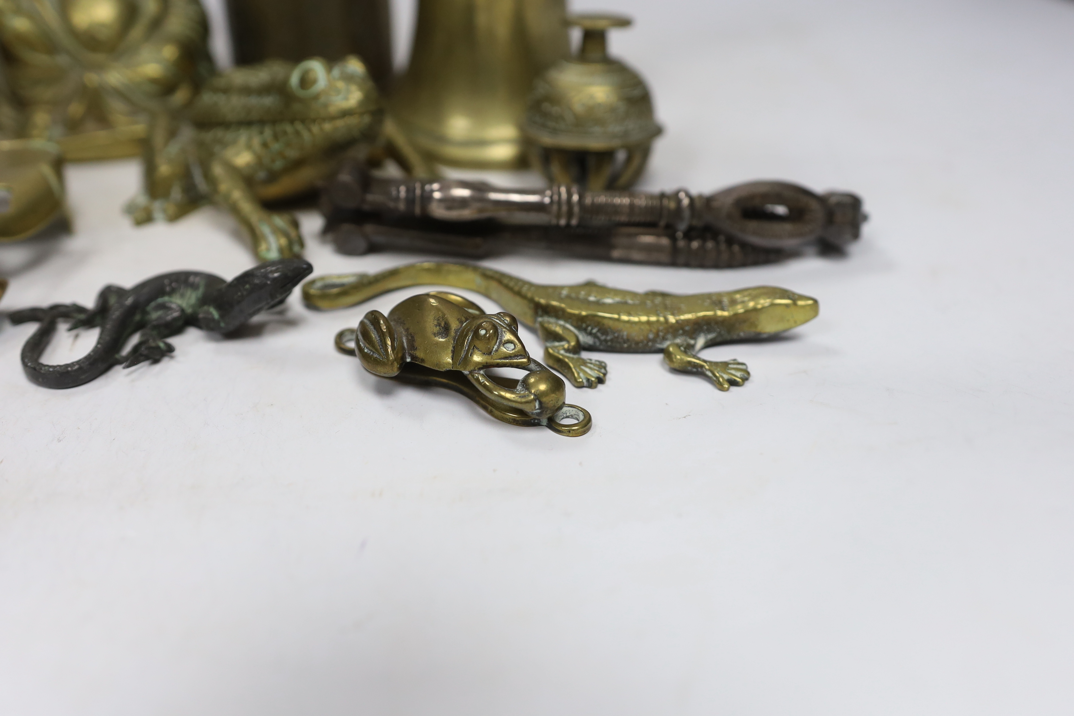 Sundry metalware including hinged brass frog with compartment, nutcrackers, a seated Buddha and a 925 gilt enamel spoon